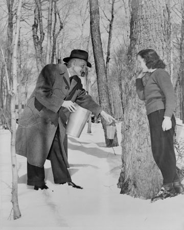 Man explaining the sap collecting process, Qubec, c.1945., © CMC/MCC, J4335