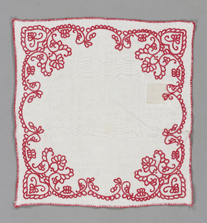 This densely textured breadcloth is handspun and embroidered with red cotton and floral motifs., © CMC/MCC, 76-358