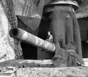 A man sits on top of a large cannon at the Canadian War Museum in Ottawa.